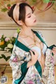 a woman in a kimono is posing for the camera