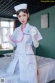 A woman dressed as a nurse holding a stethoscope.