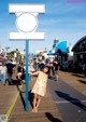 A woman standing in front of a sign that says Santa Monica 66.