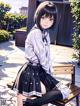 A girl in a school uniform sitting on a bench.