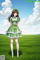 A girl in a green dress standing in a field.