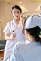 A nurse talking to a patient with a stethoscope.