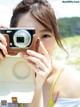 A woman taking a picture of herself with a camera.